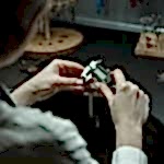 A jeweler uses a caliper to measure with precision in a professional workshop.